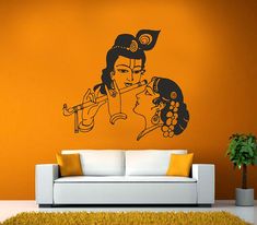 a living room with an orange wall and a white couch