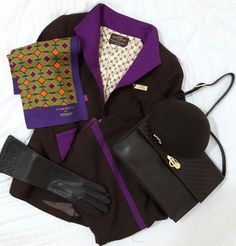 an assortment of men's clothing and accessories laid out on top of a bed