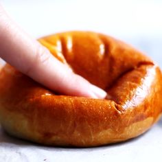 a close up of a person touching a doughnut