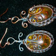 Created Amber Gemstones In Wire Wrapped Design Pierced Earrings" ...These Awesome Amber Gemstone Earrings Are Hand Wrapped Wire Around The Gemstone. The Wiring Throughout Is Done In More Than 1 Type Of Wire Finishes From A Copper To A Darker Finish. They Dangle To 2-1/2" And Are For Pierced Ears Only! This Seller Really Loves The Color Combinations On The Wire And The Lab Created Amber Stone. You Can See Inclusions In The Amber Making Them More Interesting If You Can Figure Out What's Inside! Th Amber Gemstone, Amber Stone, The Wire, Hand Wrap, Pierced Earrings, Pierced Ears, Earings Piercings, Gemstone Earrings, Ear Piercings