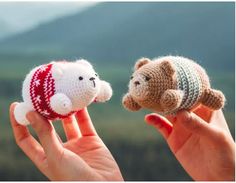 two small stuffed animals are held in their hands