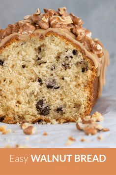 a close up of a piece of cake with walnuts and frosting on it