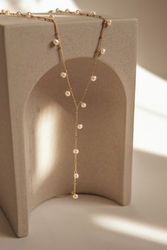 The Aries Pearl Necklace is an versatile piece handcrafted using gold-filled beaded chain and mini freshwater pearls. The design is reminiscent of art nouveau and will add a touch of creativity to your outfit. Adjustable 5cm additional chain in the back to adjust length with a hanging pearl. Packaged in an elegant plastic-free reusable jewelry box, they make the perfect gift or special treat for oneself.  14k gold-filled components Freshwater pearls Hypoallergenic, suitable for even the most sensitive skin Delivered in a 100% silk jewelry pochette inside a gift box Sustainable magnetic closure jewelry box and customizable card   Please note, as we use only natural pearls, shape and size may vary slightly.  We offer a one year guarantee from the date of delivery and unlimited repairs. 14k Gold Filled Pearl Chain Necklace, Elegant Yellow Gold Pearl Necklace With Beaded Chain, Elegant Rose Gold Beaded Chain Necklace, Elegant Beaded Chain Lariat Necklace With Dangle, Elegant Lariat Necklace With Beaded Dangle Chain, Elegant Lariat Necklace With Beaded Chain Dangle, Elegant Lariat Necklace With Beaded Chain, Adjustable 14k Yellow Gold Filled Pearl Necklace, 14k Yellow Gold-filled Pearl Necklace With Adjustable Chain