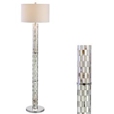 a lamp that is on top of a table next to a floor lamp with a white shade