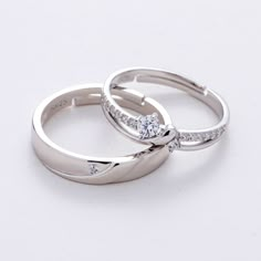 two white gold wedding rings with diamonds on each one and the other set in 18k white gold