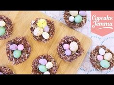 small nests filled with eggs sitting on top of a wooden cutting board