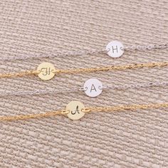 So pretty and delicate! Personalize the dainty disk with a hand stamped initial or meaningful symbol (heart). Layer this with other bracelets for the perfect look. Great gift idea for Bridesmaid, Birthday, and all meaningful days. This bracelet comes with an adjustable extender chain that has a tiny cute teardrop charm hanging at the end of the chain. ** Please be sure to LEAVE your desired initial at check out. Maximum 10 letters or numbers! ** Stamping Letter: 2.5 mm Script or Classic. (see th Delicate Adjustable Round Charm Bracelet, Dainty Adjustable Name Bracelet With Initials, Dainty Adjustable Bracelet With Initials, Personalized Dainty Charm Bracelet, Personalized Dainty Name Bracelet, Dainty Engraved Adjustable Charm Bracelet, Dainty Personalized Charm Bracelet, Dainty Engraved Charm Bracelet, Dainty Name Bracelet For Bridesmaid Gift