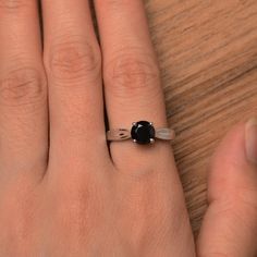 It is a natural black spinel ring. The main stone is 7mm*7mm round cut, weight about 1.65 carats. The basic metal is sterling silver and plated with rhodium. To change the metal to a solid gold (white/rose) or platinum is also available, please ask for a quotation if you want. You can also go to my shop Home for more elegant rings: https://www.etsy.com/shop/godjewelry?ref=hdr_shop_menu More black spinel rings: https://www.etsy.com/shop/godjewelry?ref=seller-platform-mcnav&section_id=21680005 Round Cut Solitaire Engagement Ring, Black Spinel Ring, Spinel Ring, Black Spinel, Elegant Ring, Round Cut, Womens Engagement Rings, Solitaire Ring, Solitaire Engagement Ring