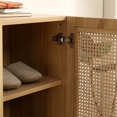 a wooden cabinet with some shoes on it