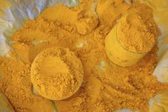 yellow powder in a bowl with two spoons