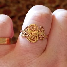 Super cute and delicated tradicional Portuguese Gold Filigree Lady Ring, Handmade with the iconic design Coração de Viana from the Minho Region. The traditional Portuguese Gold has a 800/1000 purity, 19.2 Carats Gold, wich is the most valuable gold under the 22kt from gold coins and 24kt from investment gold bars.  It is adjustable, perfect for any size finger person, and also allows you to wear the ring on any finger you want, for different looks. It has and Intricated design filled with cornuc Ornate Engraved Yellow Gold Filigree Ring, 14k Gold Jewelry With Intricate Design For Marriage, Traditional Yellow Gold Filigree Ring For Formal Events, Traditional Yellow Gold Filigree Ring For Formal Occasions, Vintage Gold Filigree Ring With Intricate Design, Gold Vintage Filigree Ring With Intricate Design, Hallmarked Filigree Toe Ring For Wedding, Vintage Yellow Gold Engraved Filigree Ring, Heirloom Gold Engraved Filigree Ring