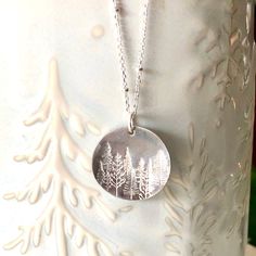 (CANADA POST STRIKE! - DO NOT PLACE ORDERS AT THIS TIME ) A stunning silver pine tree necklace for the nature lover! This piece is hand stamped with a lovely forest scene of our beautiful surroundings. A perfect gift to give the nature enthusiast! 🌿 Chain is a solid sterling silver satellite chain. You may choose your length at checkout. 🌿 Choose to have stars in your sky, or without. (shown in photos) 🌿 Silver disk is 2cm in diameter and made from alkeme. Please see all photo's for size refe Forest Necklace, Stained Glass Earrings, Leather Jewelry Making, Hand Stamped Ring, Stamped Earrings, Plant Jewelry, Tree Jewelry, Nature Earrings, Stamped Bracelet