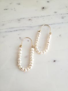 ∙These pearl hoop earrings are super femme and perfect for dressing up a simple outfit! Would also be wonderful for a bride with a bit of vintage flair. ∙Unique shape is sure to catch you some compliments. ∙Nice and lightweight on the ear! ∙Top quality materials are excellent for sensitive ears/skin. ∙These measure ~2.25 inches long. ~M A T E R I A L S ~ Choose from- * 925 Sterling silver *14k Gold fill *14k Rose gold fill **What is 14k Gold-fill?** Gold fill does not tarnish or wear off and con Pearl Chain Hoop Earrings For Wedding, Elegant Pearl Chain Hoop Earrings For Wedding, Elegant Hoop Earrings With Pearl Chain For Wedding, White Pearl Embellished Hoop Earrings For Wedding, Chic Pearl Embellished Earrings For Wedding, Classic Wedding Hoop Earrings With Pearl Chain, Wedding Pearl Chain Hoop Earrings, Small Pearl Hoop Earrings For Wedding, Pearl Embellished Hoop Earrings For Wedding