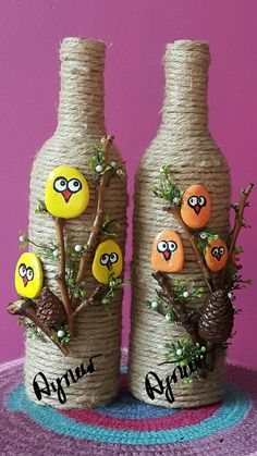 two decorated wine bottles sitting on top of a table