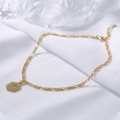 Make a sophisticated personal style statement and add a dash of luster to any ensemble with this sublime anklet. Beautifully crafted in sterling silver, it will help you represent your initial with elegant flair. Give personalized jewelry gift - represent your initials in style with this small tag on a beautifully crafted figaro chain.Weight: 4.548 gWidth: 9.9 mmHeight: 13.4 mmThickness: 1.8 mmMaterial: 925 SilverStone Type: Jeulia® StonePlating Color: Yellow GoldLength: 270 mm Elegant Sterling Silver Anklets With Adjustable Chain, Gold Sterling Silver Anklet As Gift, Personalized Silver Anklets, Adjustable Gold Sterling Silver Anklets, Personalized Gold Elegant Anklets, Personalized Adjustable Elegant Anklet, Elegant Adjustable Chain Anklet As Gift, Elegant Personalized Adjustable Anklet, Elegant Personalized Gold Anklets