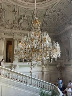 a chandelier hanging from the ceiling in a large room