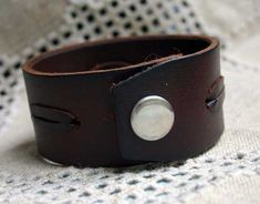 This cuff bracelet is a perfect gift for Dads.However the design is UNISEX and can be worn by both men and women. Size: 10" by 1-1/2", thickness 3/8" or 4mmMaterial: natural thick distressed Italian leather and snap closure.Snap closure.Color: Brown Leather is distressed for a vintage look and may have some natural scratches. Adjustable Brown Classic Cuff Bracelet, Adjustable Classic Brown Cuff Bracelet, Adjustable Brown Leather Bracelet Gift, Adjustable Vintage Brown Leather Bracelet As Gift, Adjustable Vintage Brown Leather Bracelet Gift, Adjustable Vintage Brown Leather Bracelet, Classic Handmade Adjustable Cuff Bracelet, Adjustable Brown Cuff Bracelet For Everyday, Handmade Adjustable Cuff Bracelet For Everyday Use