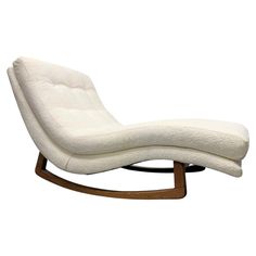 a white chair with a wooden frame and foot rest on it's back legs