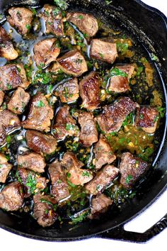 meat and vegetables cooking in a skillet