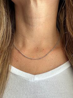 Our favorite layering chain necklace is the Delilah Beaded Satellite chain.    This delicate Stainless Steel or 14K Gold Plated Stainless Steel chain necklace sits close to the neck and features tiny 2mm beads every 2cm.    Wear it on its own for a simple and chic look or pair it with your other favorite necklaces for the ultimate layered look.   Bring instant dimension and flair to your stack with the Delilah Beaded Satellite chain.  Safe for sensitive skin & shower safe. ITEM DESCRIPTION ❤ Choker Necklace ❤ Color:  available in Silver or 14K Yellow Gold ❤ Length: 15 in + 2 in extender ❤ Material: Stainless Steel or 14K Gold Plated Stainless Steel ❤ Sold Individually  ❤ Free Shipping  P R O M O T I O N ✦ 20% Discount is applied for purchases of 2 or more products. Coupon Code: 20FORYOU ✦ Everyday Station Necklace With Satellite Chain, Beaded Chain Necklace For Everyday, Minimalist Beaded Chain Layered Necklace, Silver Chain Necklace With Round Beads And Adjustable Chain, Everyday Round Beads Charm Necklace, Trendy Ball Chain Necklace As Gift, Dainty Beaded Chain Layered Necklace, Trendy Ball Chain Necklace For Gift, Minimalist Everyday Beaded Chain Layered Necklace