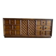 a wooden dresser with many drawers and knobs on it's doors, against a white background