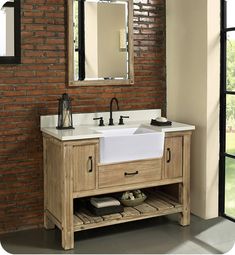 a bathroom with a brick wall and white sink under a mirror next to a window