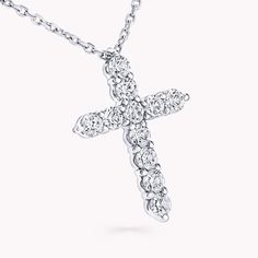 A precious interpretation of a classic motif, our mini cross pendant in white gold is available in a variety of different carat weights, seen here with 0.05 carat diamonds. Deftly suspended from a white gold chain, each diamond is embraced by a minimal metal setting, optimising their brilliance and presence. The Classic Graff collection celebrates the purity and fire of the finest Graff diamonds showcased in truly timeless jewels and eternally elegant silhouettes. An elegant Classic Graff cross Timeless Silver Cross Pendant Necklace, Luxury White Gold Cross Necklace, White Gold Formal Cross Pendant Necklace, Luxury White Gold Cross Necklace For Formal Occasions, Classic White Gold Crucifix Necklace, Diamond White Brilliant Cut Cross Pendant Necklace, Diamond Cross Necklace With Prong Setting, Classic Diamond Pendant Cross Necklace, Luxury White Gold Cross Necklace With Diamond Accents