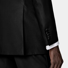 This black tuxedo is cut to a tailored fit with a slim chest and waist for a fitted silhouette and padded shoulders. Paired with straight leg trousers featuring flat-front and side-adjusters. Mohair Fabric, Custom Made Suits, Black Weave, Unique Fits, Suit Pant, Black Tuxedo, Classic Suit, Tuxedo Suit, Straight Leg Trousers