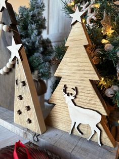 two wooden christmas trees sitting next to each other