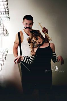 a man and woman with fake mustaches on their heads