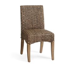 a brown wicker chair sitting on top of a white floor next to a wooden frame