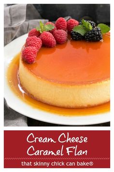 a cheesecake topped with raspberries and caramel flan on a white plate