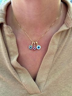 Dainty and waterproof, our Evil Eye necklace is the perfect everyday staple piece! Information: 🧿 18K Gold Filled (stamped) 🧿 Hypoallergenic 🧿 Tarnish Resistant 🧿 Waterproof Our Evil Eye necklace is carefully crafted with a high level of craftsmanship and attention to detail. For instance, you can see this in the high polishing of the necklace to the waterproof properties. The charm is reversible, you will be able to see the Evil Eye on both sides of the charm. Our necklace comes in 3 colors:  🧿 Red 🧿 Blue 🧿 White If you would like a longer length than what is listed, chain extensions are available upon request free of charge.  The Evil Eye 🧿 is known as a talisman of protection against evil energies, keeping the wearer safe from harm. This necklace makes a great gift. Everyday Blue Necklaces With Charms, Everyday Blue Necklace With Charms, Red Round Pendant Charm Necklace, Everyday Evil Eye Charm Necklace, Handmade Red Necklace For Everyday, Everyday Handmade Red Necklaces, Red Charms Necklace With Round Pendant, Red Charms Round Pendant Necklace, Red Necklace With Charms And Round Pendant