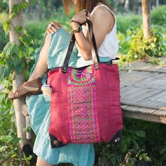 "Made with a unique piece of vintage fabric tha used to be an apron in the Hmong villages of Northern Thailand. Each piece is different as its hand embroidered by one of our artisans. The overall look of the bag is just like the pictures. You will not receive the exact bags pictured here as they are all one-of-a-kind bags. We buy materials from Hmong market and we design and sew by hand. Some of the bags we modify to improve the product. The Hmong tribes live in the North of Thailand and have or Traditional Red Bag For Market, Traditional Red Hand-stitched Bags, Vintage Embroidered Bags For Festivals, Vintage Red Shoulder Bag For Festivals, Traditional Red Embroidered Shoulder Bag, Red Embroidered Bohemian Shoulder Bag, Bohemian Red Embroidered Shoulder Bag, Red Bohemian Embroidered Shoulder Bag, Festival Red Handwoven Shoulder Bag