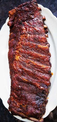 a piece of meat sitting on top of a white plate