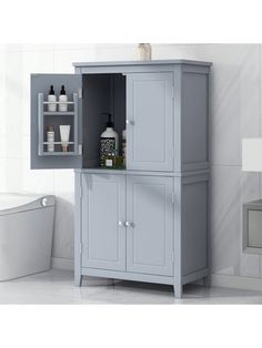 a bathroom cabinet with two doors and shelves on the side, next to a bathtub