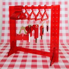 a red and white checkered table cloth with an ornament holder on it