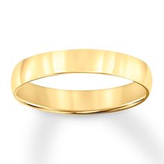 a yellow gold wedding ring on a white background