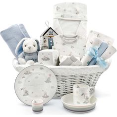 a white basket filled with baby items on top of a table next to a stuffed animal