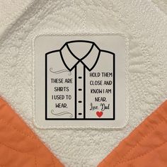 an orange and white quilt with a patch on it that says, these are shirts i used to wear