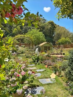 the garden is full of flowers and plants