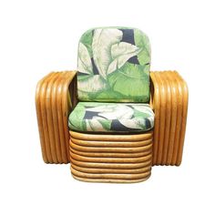 a green and white chair sitting on top of a stack of wooden chairs next to each other