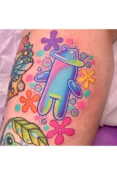 a colorful tattoo on the leg of a woman