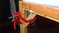 a pair of pliers is attached to the bottom of a bunk bed