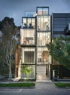 a tall building with lots of windows on top of it's sides at night