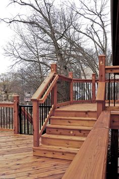 a wooden deck with railing and hand rail