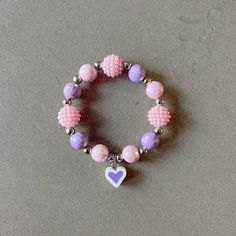 Pink bracelet for girl kid beaded bracelet for kids purple heart bracelet pink beads necklace for children heart charm bracelet gift for kid This delightfully cute Kids bracelet is perfect for your little one! Constructed with an elastic cord, it is both easy and safe for your child to put on and take off. The colorful pink and purple beads, paired with the heart charm, make this bracelet the perfect accessory for your kid. Item Details *Material: Acrylic, Rice beads, Silicone *Bracelet size: 5i Personalized Pink Dainty Beaded Bracelets, Cute Heart Bracelet With Round Beads For Valentine's Day, Purple Heart-shaped Beaded Jewelry, Valentine's Day Playful Beaded Jewelry, Cute Heart Beads Charm Bracelet For Valentine's Day, Cute Heart Beads Beaded Bracelets For Valentine's Day, Cute Heart Beaded Bracelets For Valentine's Day, Cute Heart-shaped Beaded Bracelets For Valentine's Day, Adjustable Purple Charm Bracelet For Birthday