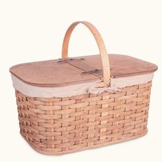 a wicker picnic basket with leather lining