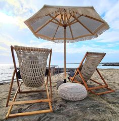 two chairs and an umbrella on the beach