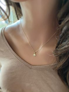 "This solid 14k gold charm is stunning and has a great detail. The slightly curved sun beams and its dome shape add dimension. The pendant measures approximately 8 mm. Now available with the 16 or 18\" dainty solid 14k gold chain. The sun will be suspended on 4 mm open bail (see 1st photo) If you only purchasing the charm, select bail size: 4 mm 14k open jump ring bail and can accommodate chains up to 1.6 mm. 6 mm 14k closed bail that can suit thicker necklaces. Hallmarked 14K 14k sand dollar ch Elegant Gold Starburst Jewelry, Dainty Starburst Yellow Gold Jewelry, Gold Dainty Sun Design Charm Necklace, 14k Gold Starburst Jewelry Gift, 14k Gold Starburst Jewelry For Gift, 14k Gold Starburst Jewelry As Gift, Dainty Gold Charm Necklace With Sun Design, Dainty Sun Design Jewelry For Gifts, Elegant Sunburst Jewelry With Sun And Moon Design